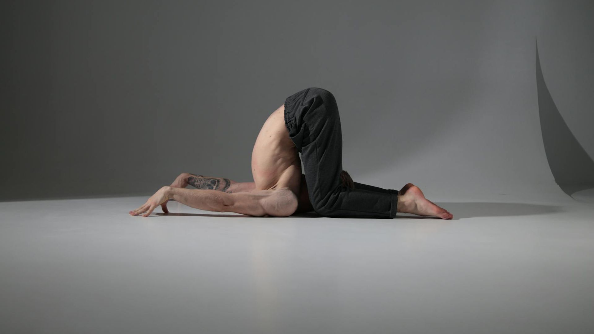 Serene yoga practitioner in a dark obsidian studio environment.